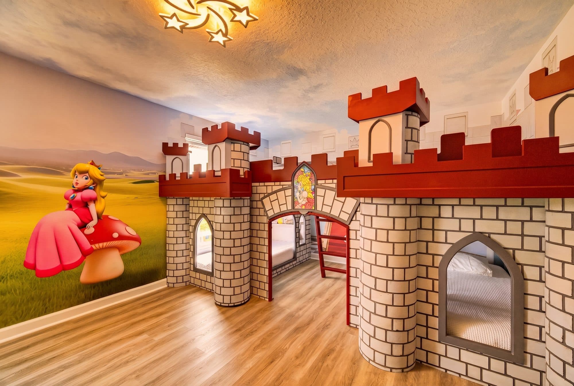 Castle bunk room with turret beds and painted landscape mural at an Orlando area themed vacation rental
