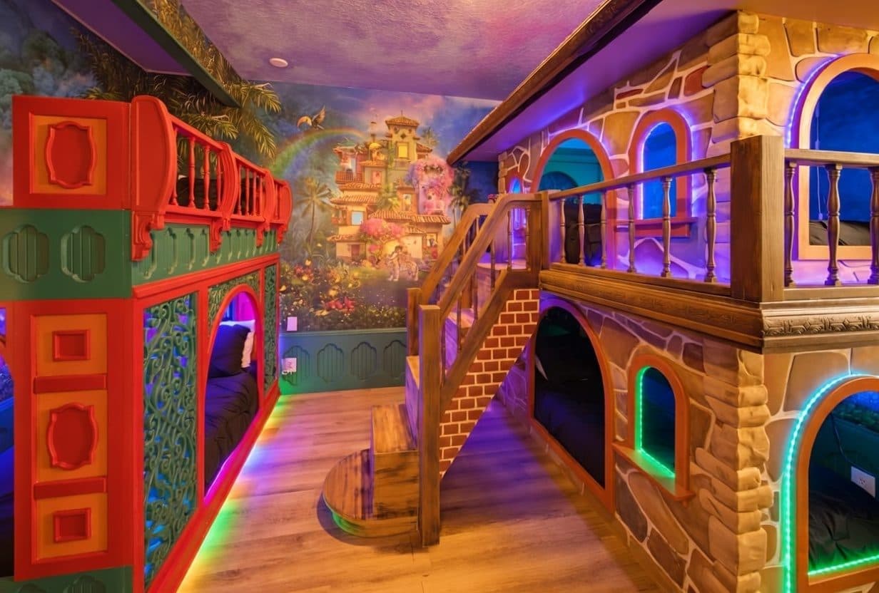 Two-storey castle bunk room with rainbow LED lighting and hand-painted mural at a Kissimmee themed vacation rental